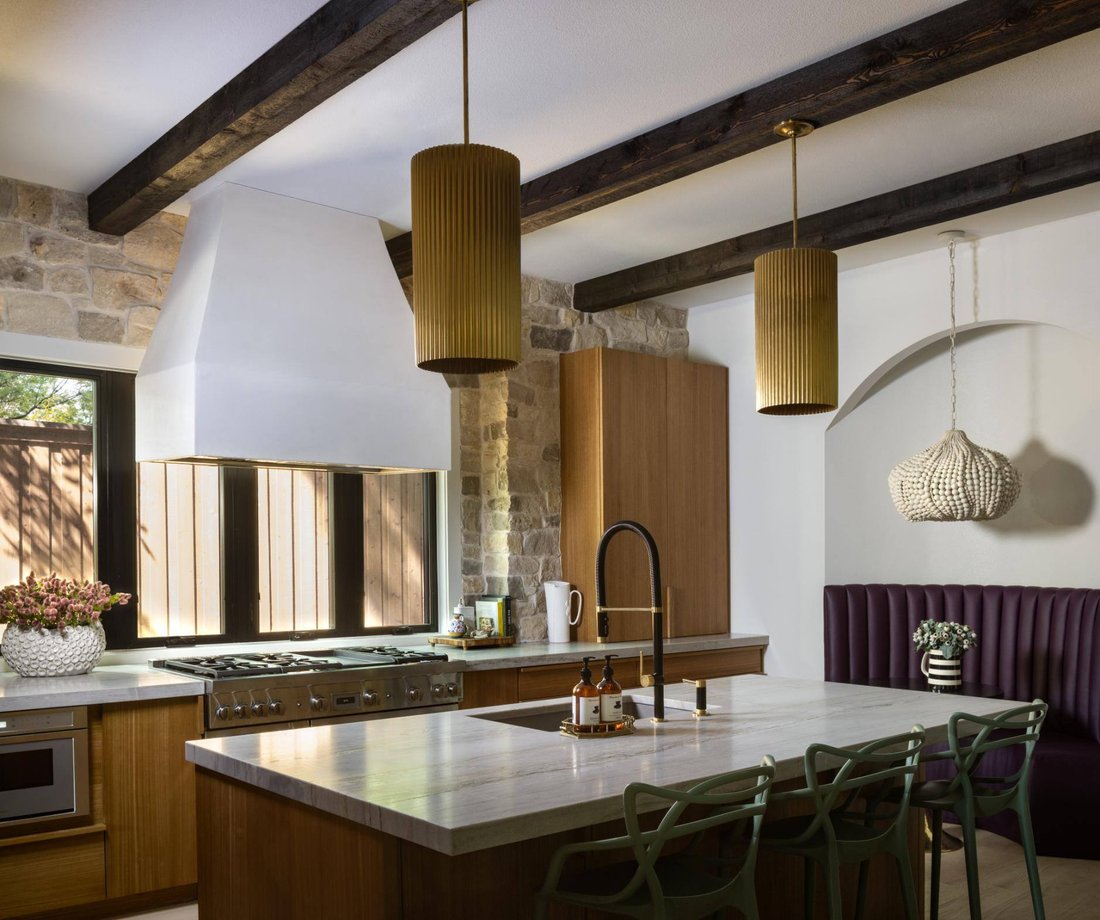 Contemporary kitchen featuring a large range hood and exposed beams, custom home by Sardone McClain in Dallas, Texas