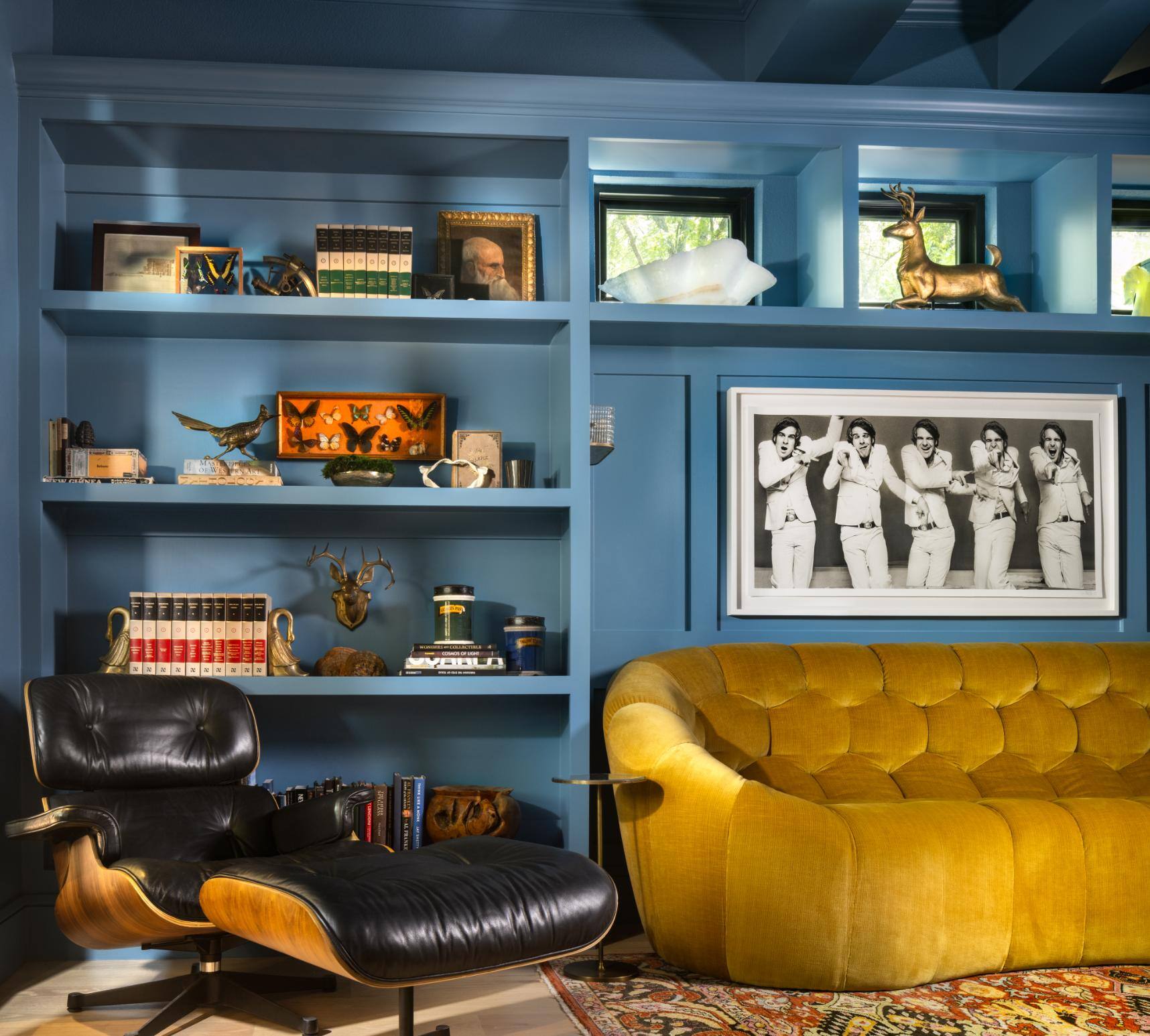 Custom living room featuring blue shelves and yellow couch, custom home by Sardone McClain in Dallas, Texas