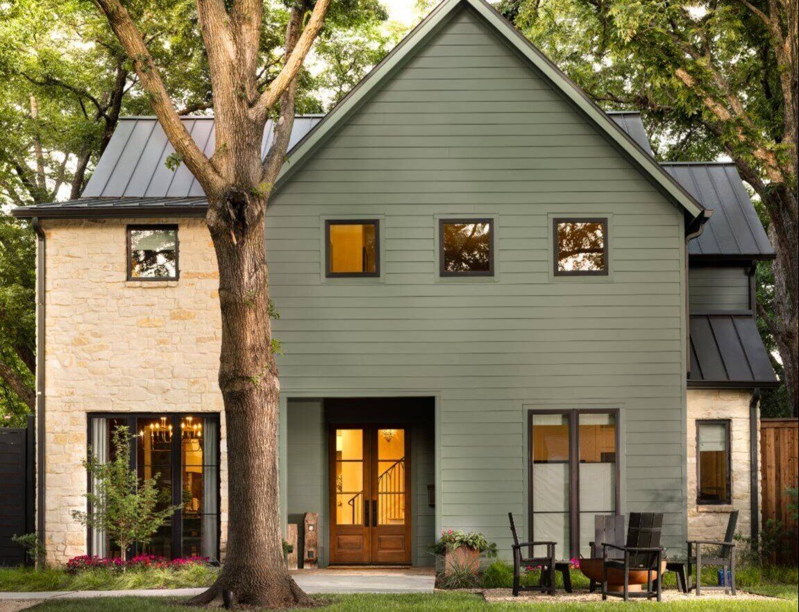 Exterior of a two-story home with green siding and a stone facade, custom home by Sardone  McClain in Dallas, Texas