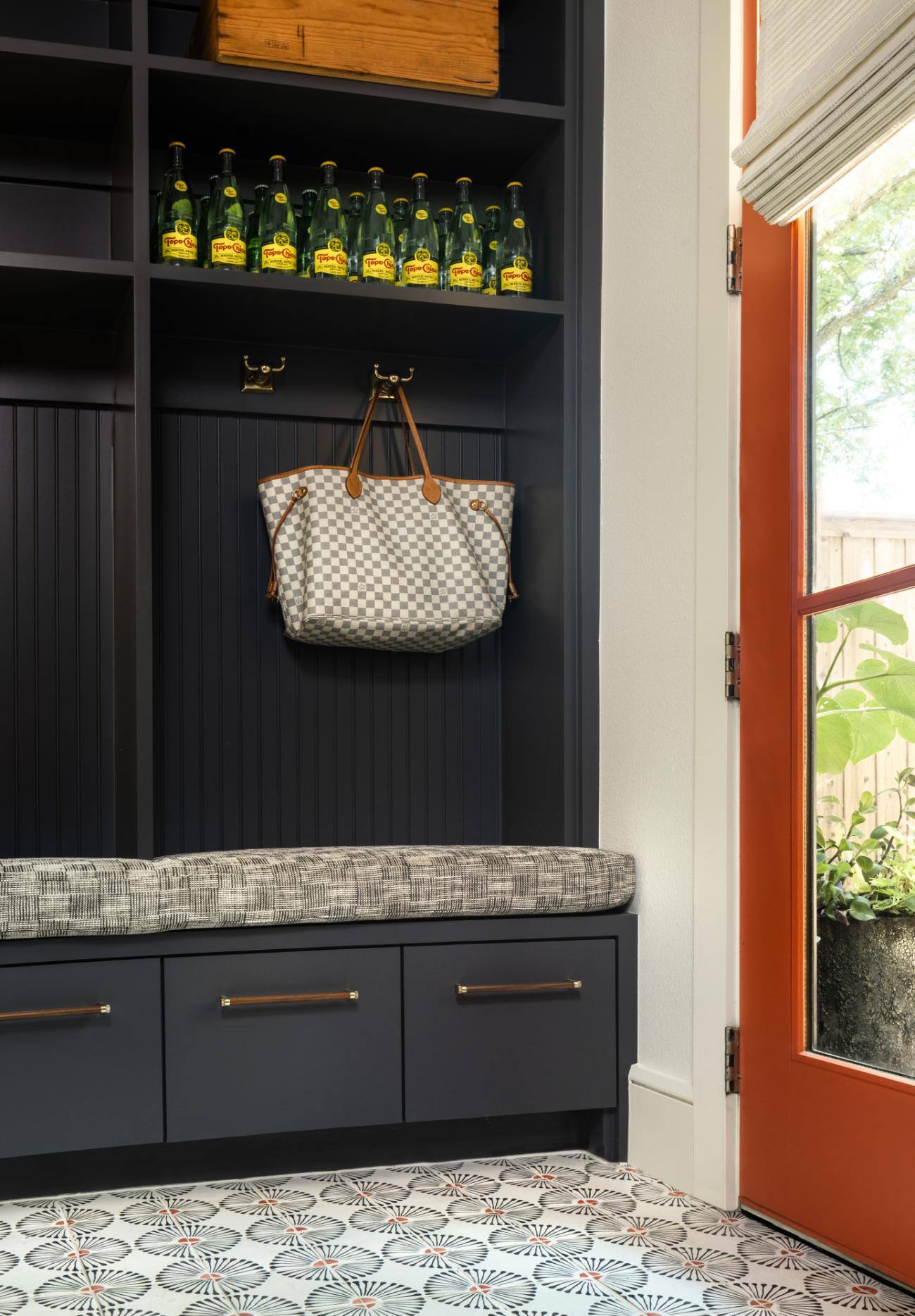 Mudroom with built-in shelves, storage and a bench seat in a custom home by Sardone McClain in Dallas, Texas