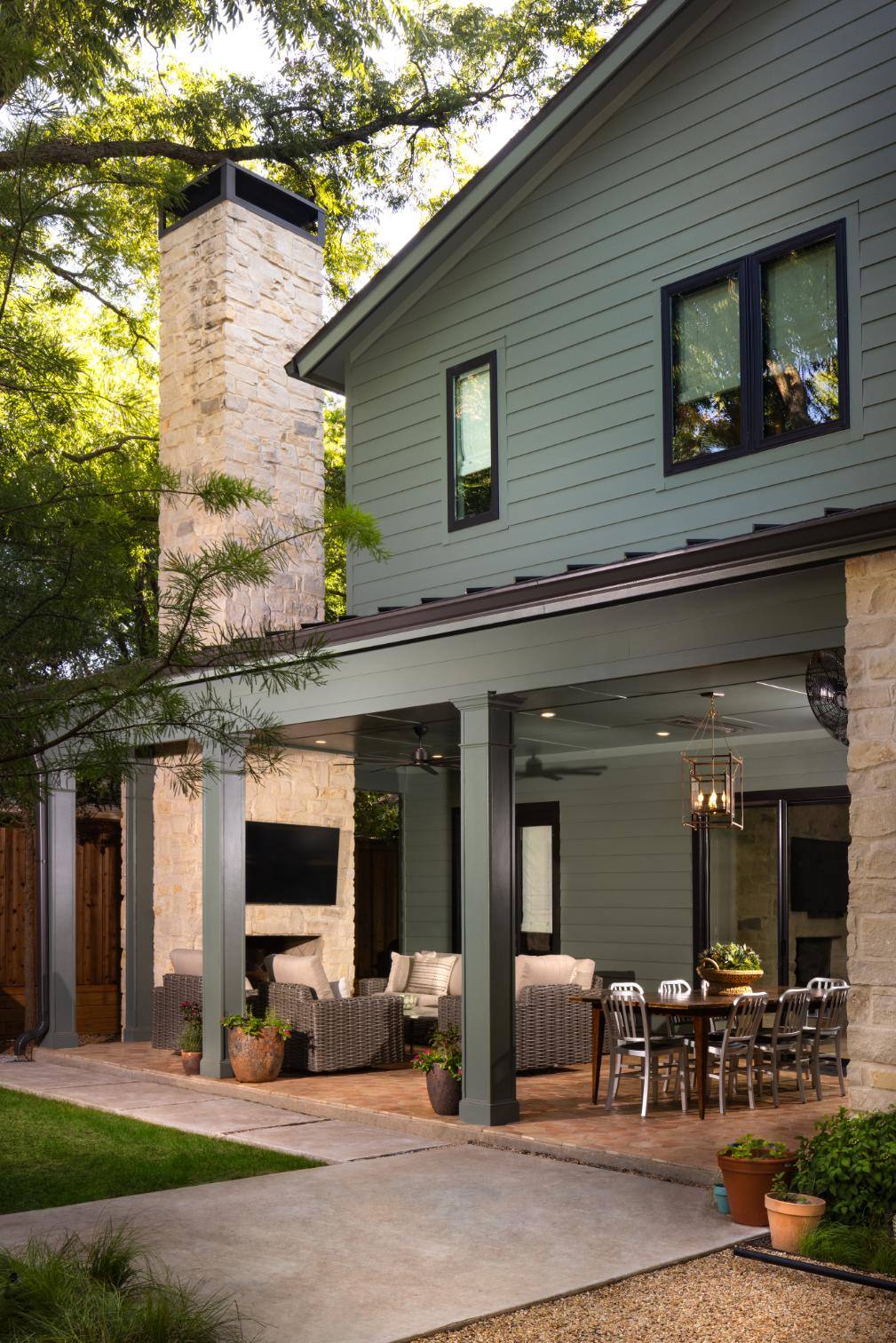 Outdoor patio with dining and seating area under a covered porch in a custom home by Sardone McClain in Dallas, Texas