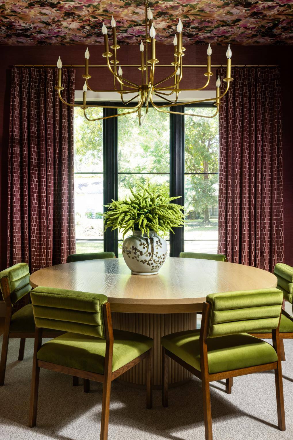 Sophisticated dining area featuring a round table and a gold chandelier, custom home by Sardone  McClain in Dallas, Texas.