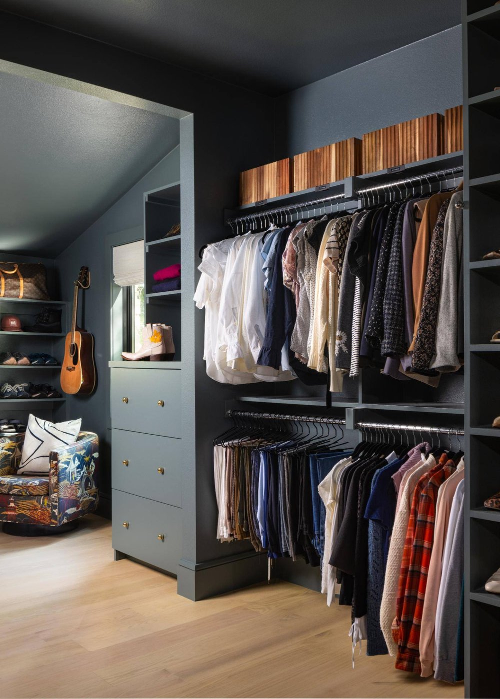 Spacious closet with hanging clothes and a seating area, custom home by Sardone  McClain in Dallas, Texas