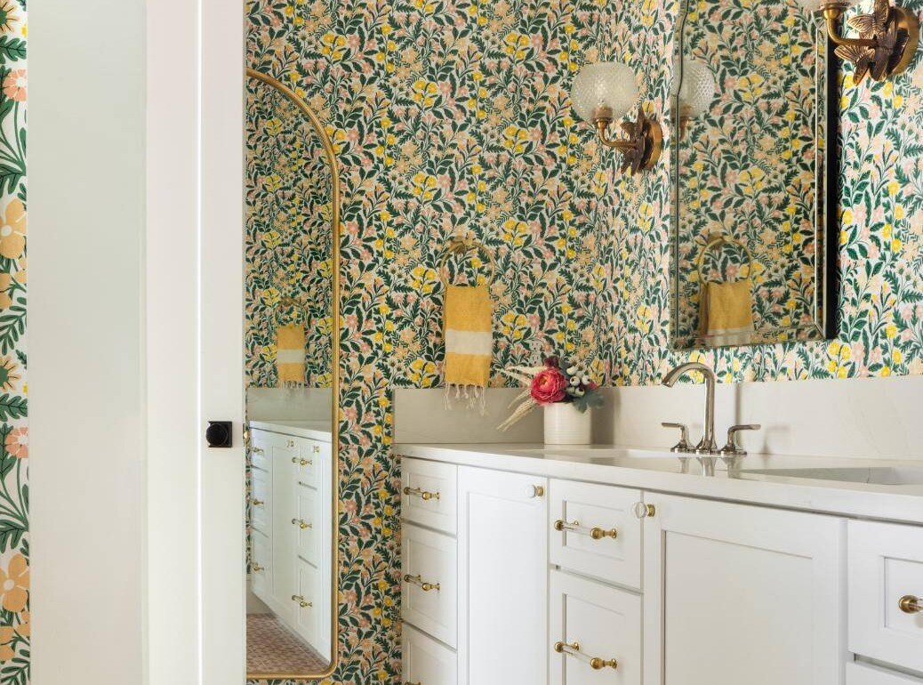 Vibrant bathroom in a custom home remodel with floral wallpaper and white cabinetry, custom home by Sardone McClain in Dallas, Texas