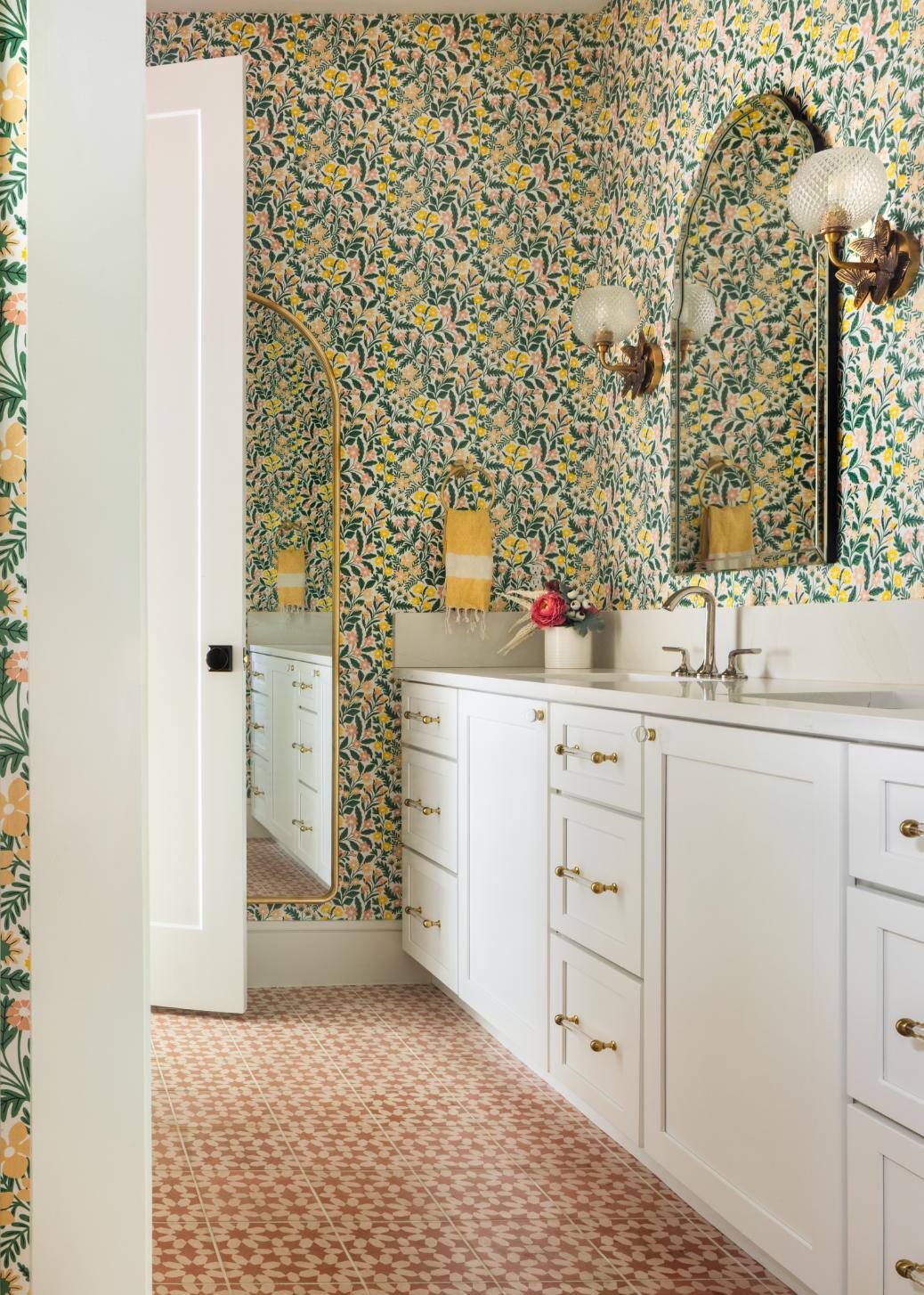 Vibrant bathroom in a custom home remodel with floral wallpaper and white cabinetry, custom home by Sardone McClain in Dallas, Texas