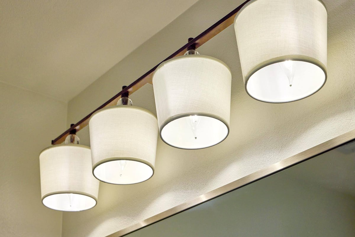 Close-up of modern bathroom light fixture in Sardone | McLain's bathroom remodel, Dallas, TX