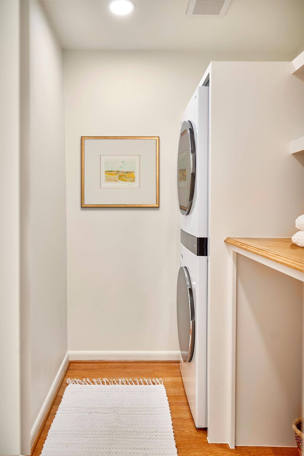 Laundry room remodel featuring stacked washer and dryer in Dallas by Sardone | McLain