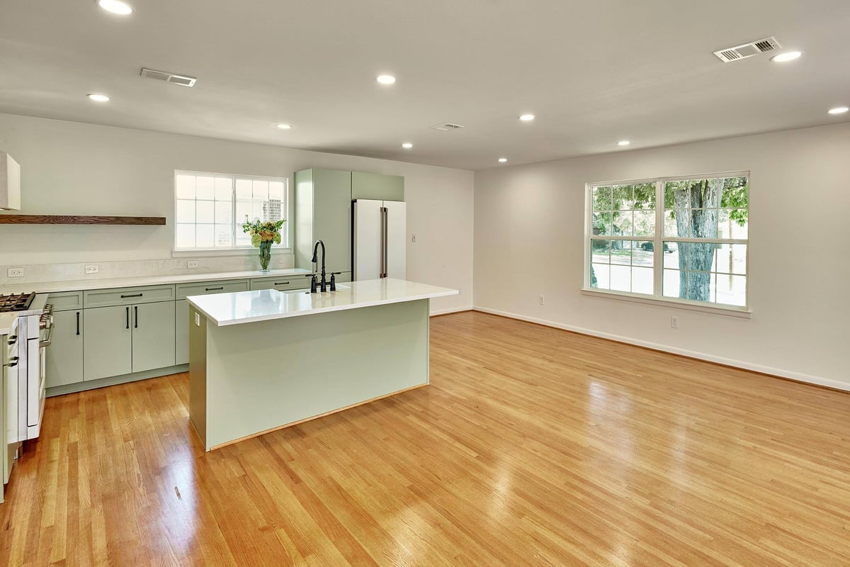 Open kitchen and dining area with large windows by Sardone | McLain in Dallas, TX