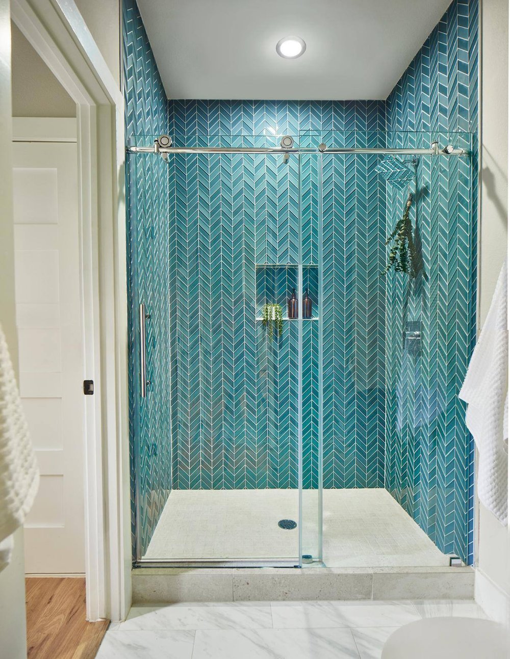 Walk-in shower with blue mosaic tiling in Dallas home remodel by Sardone | McLain in Dallas, TX