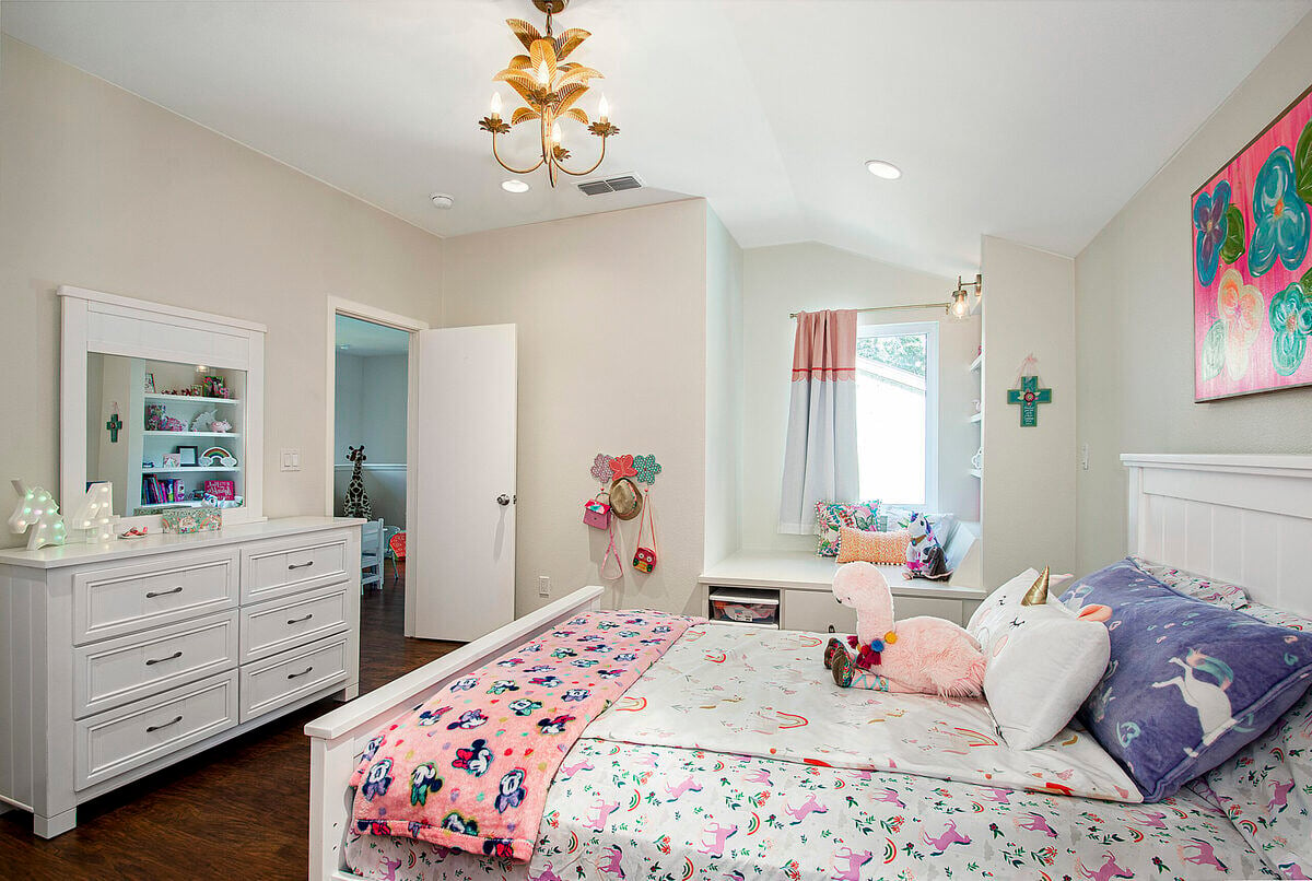 Kids bedroom with window bench and storage in home remodel by Sardone | McLain