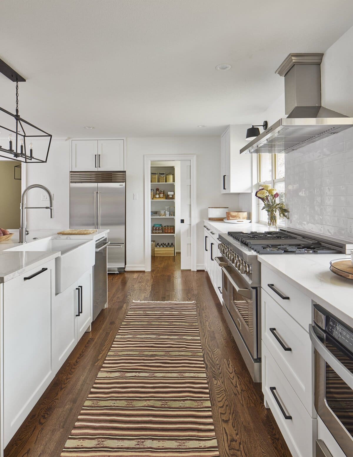 White kitchen remodel in Dallas by Sardone | McLain with door open to pantry