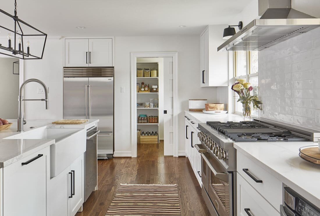 White kitchen remodel in Dallas with door open to pantry by Sardone | McLain