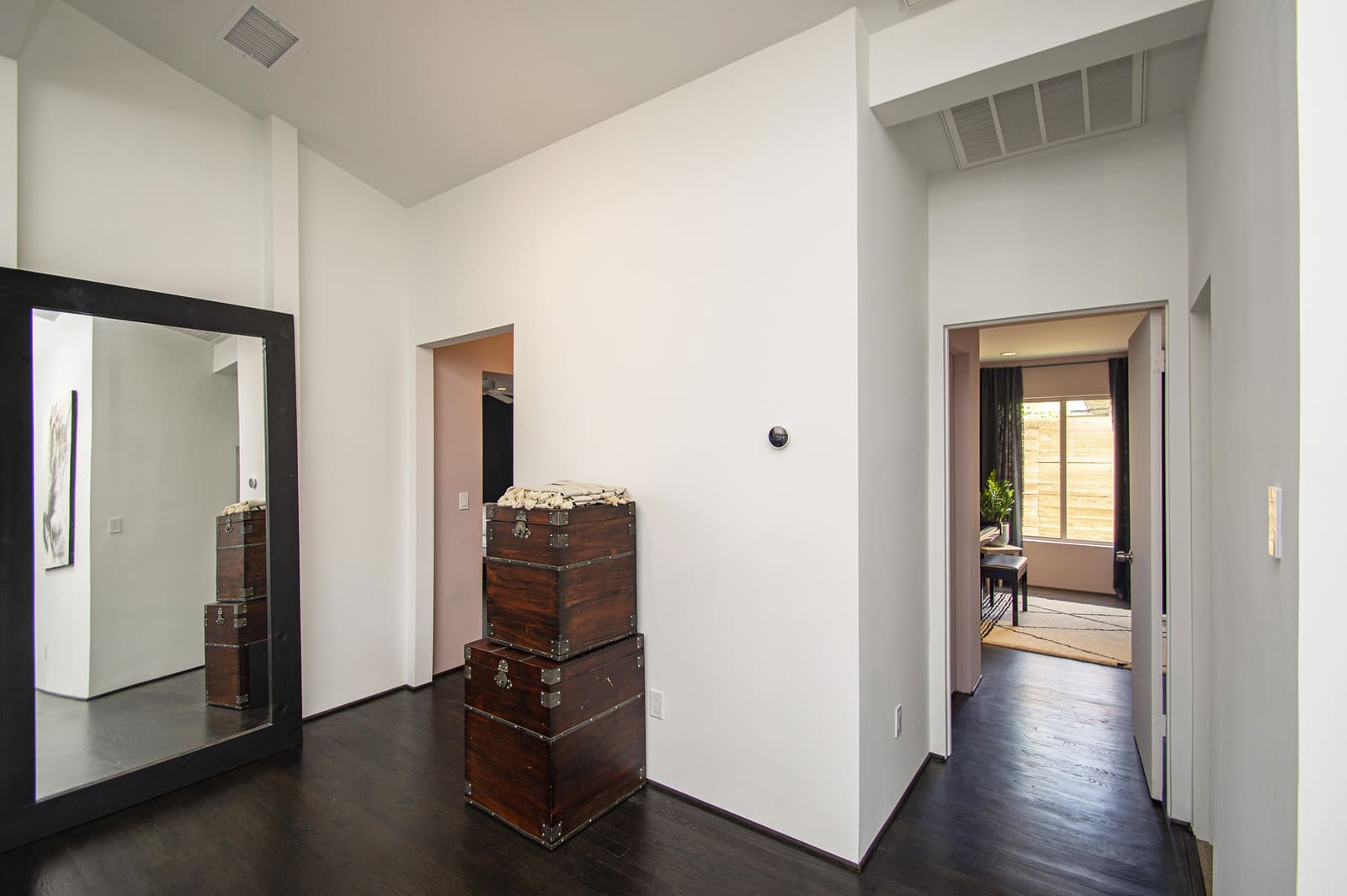 Hallway with wood flooring in Dallas, TX home remodel by Sardone | McLain