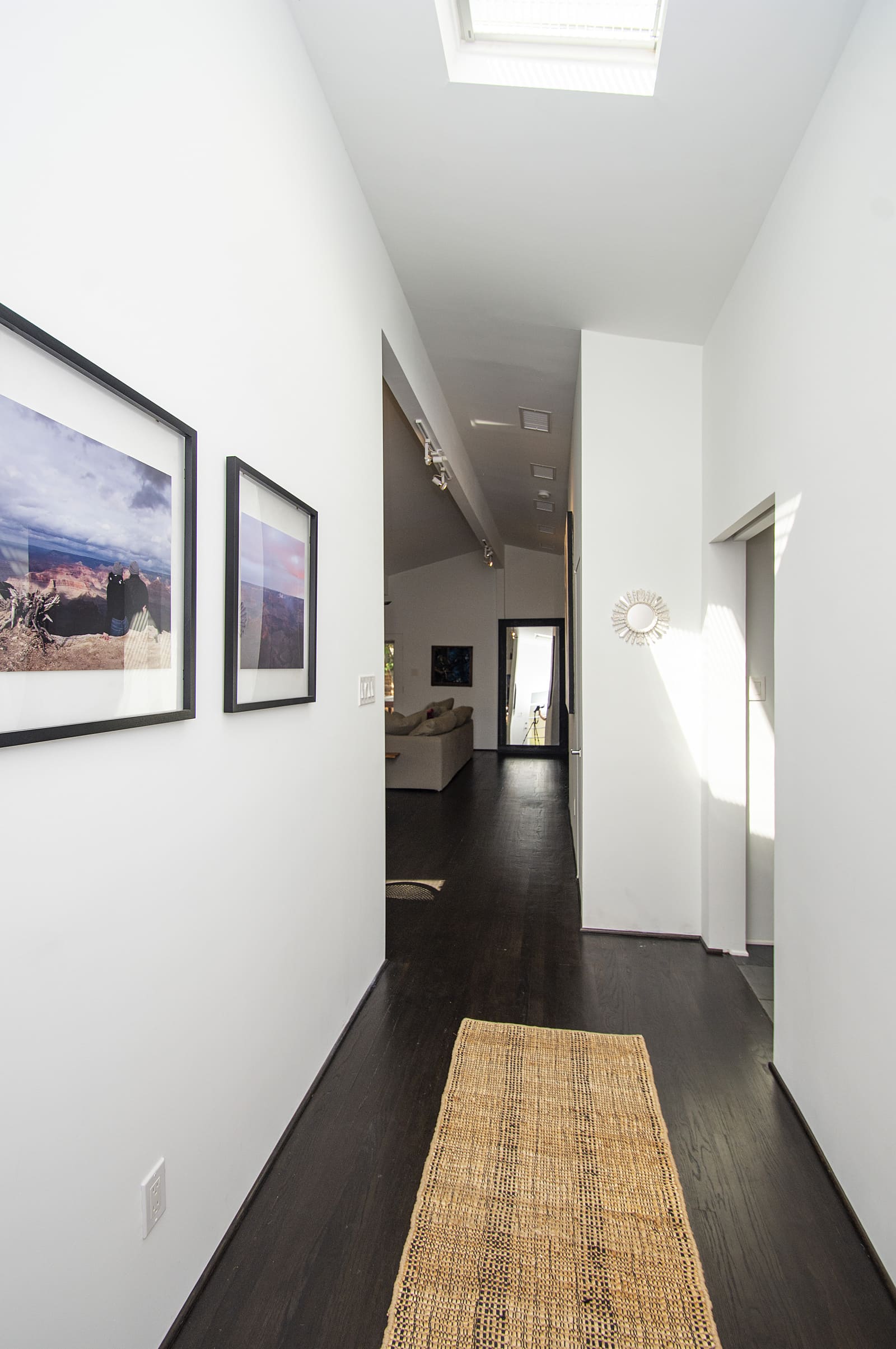 Hallway with wood flooring in Dallas, TX home remodel by Sardone | McLain