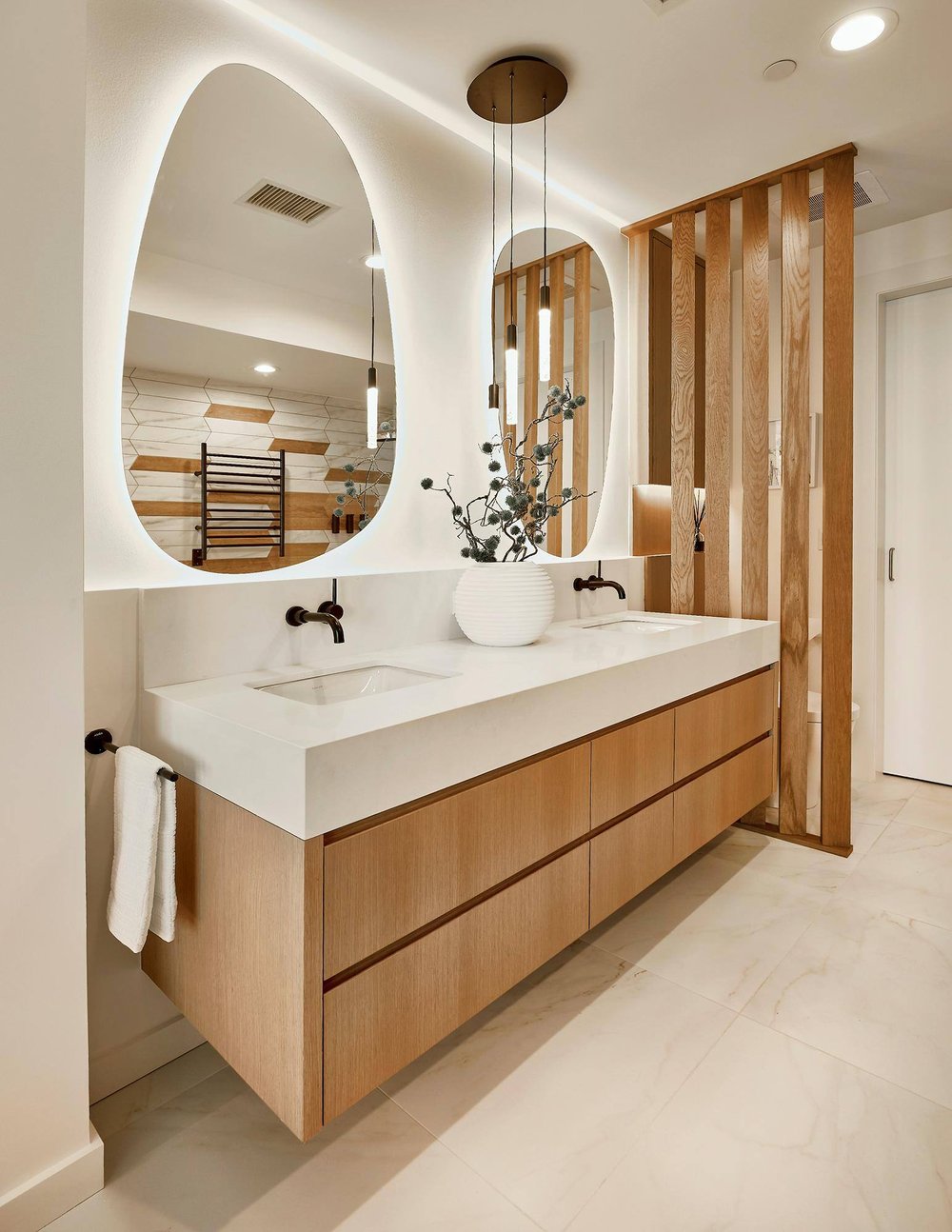 Dallas condo primary bathroom remodel with floating double wood vanity by Sardone | McLain