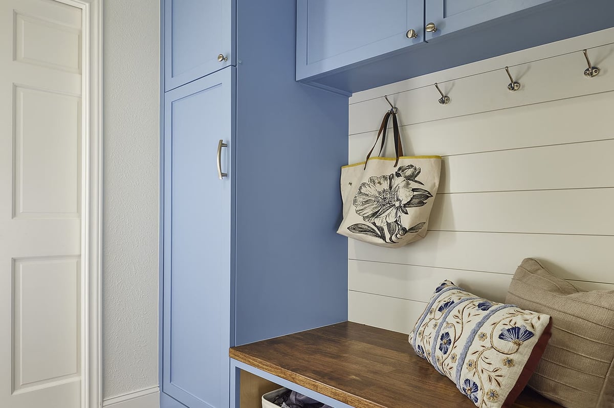 Remodeled mudroom with built-in hooks and bench by Sardone | McLain