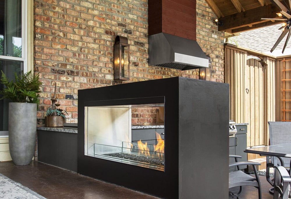 Fireplace near outdoor kitchen remodel by Sardone | McLain