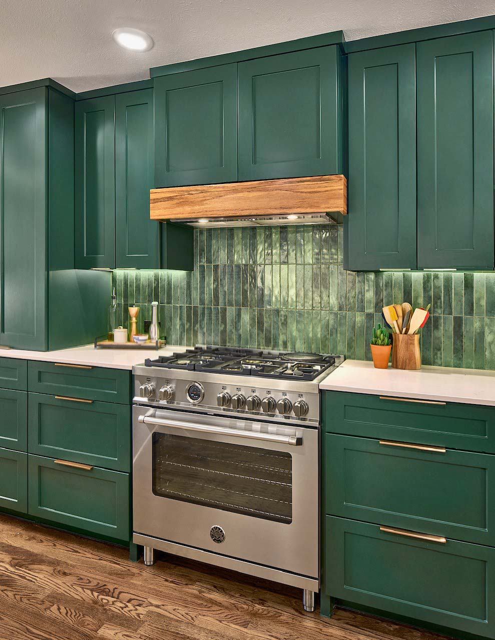 Modern green kitchen remodel in Dallas, Texas with brass cabinet fixtures and green vertical subway tile backsplash