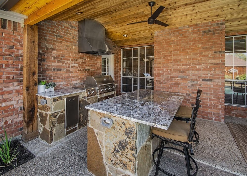 Outdoor kitchen remodel in Dallas, Texas with island and seating by Sardone | McLain